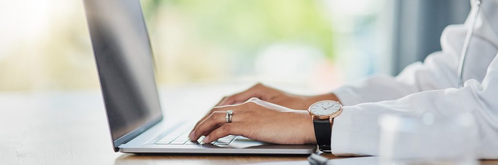 healthcare professional using laptop computer