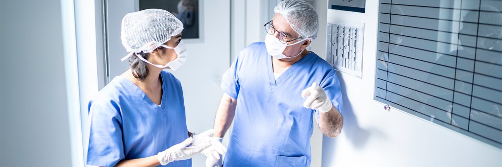 two healthcare professionals scrubbed up and ready for surgery