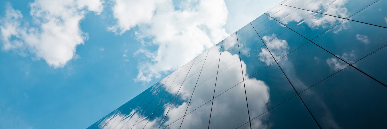 Glass walled building and clouds