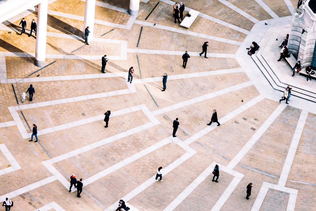 People walking through paved plaza