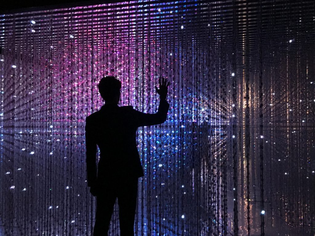 business man touching digital wall with palm of hand