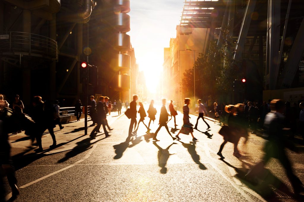 pedestrians crossing busy metropolitan street